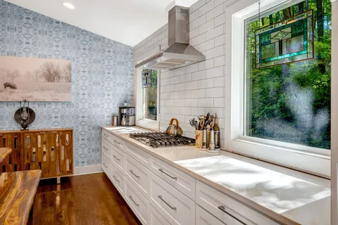 a kitchen with stainless steel appliances granite countertop a stove and a sink