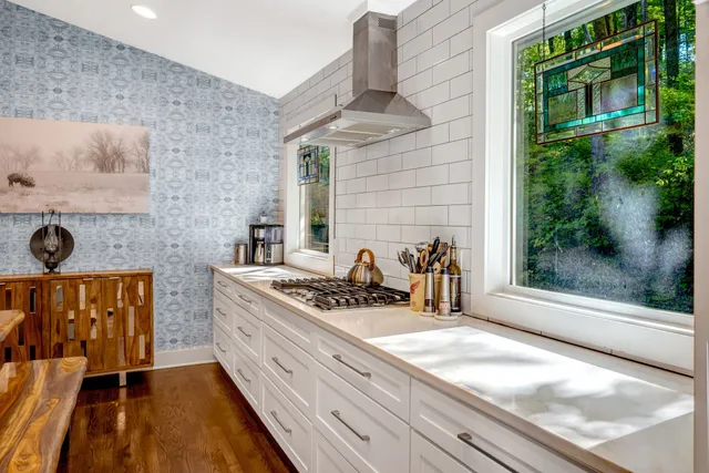 a kitchen with stainless steel appliances granite countertop a stove and a sink