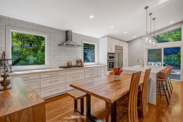 a large kitchen with a table and chairs in it