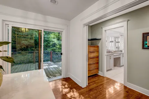 a view of balcony with wooden floor and fence