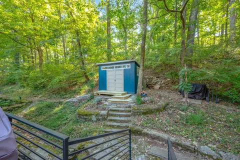 a view of a patio with table and chairs and floor to ceiling window