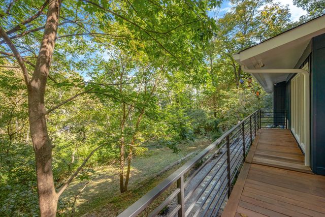 a view of a road with trees in the background