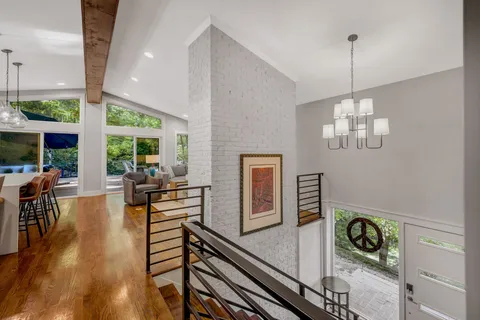 a dining room with furniture a chandelier and wooden floor