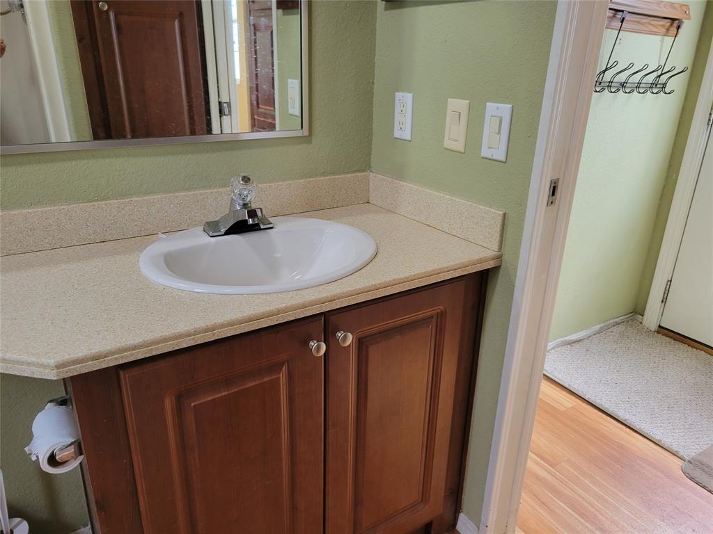 3759 Southwest 6th Avenue Okeechobee, FL 34974 - Photo 18 of 27 a bathroom with a sink and a mirror