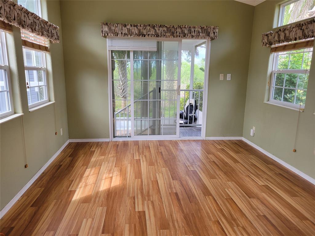 3759 Southwest 6th Avenue Okeechobee, FL 34974 - Photo 7 of 27 a view of an empty room with wooden floor and a window