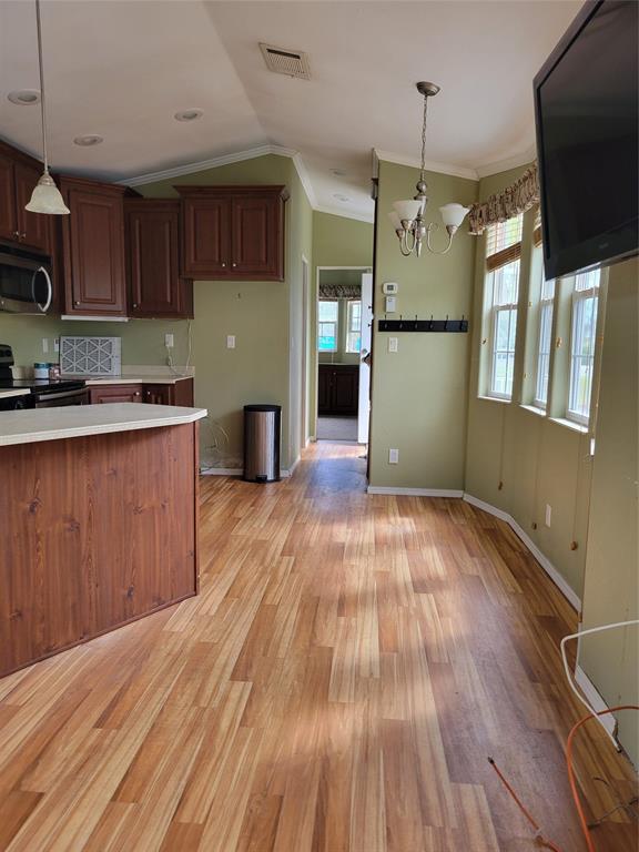 3759 Southwest 6th Avenue Okeechobee, FL 34974 - Photo 9 of 27 a kitchen with wooden floors and refrigerator