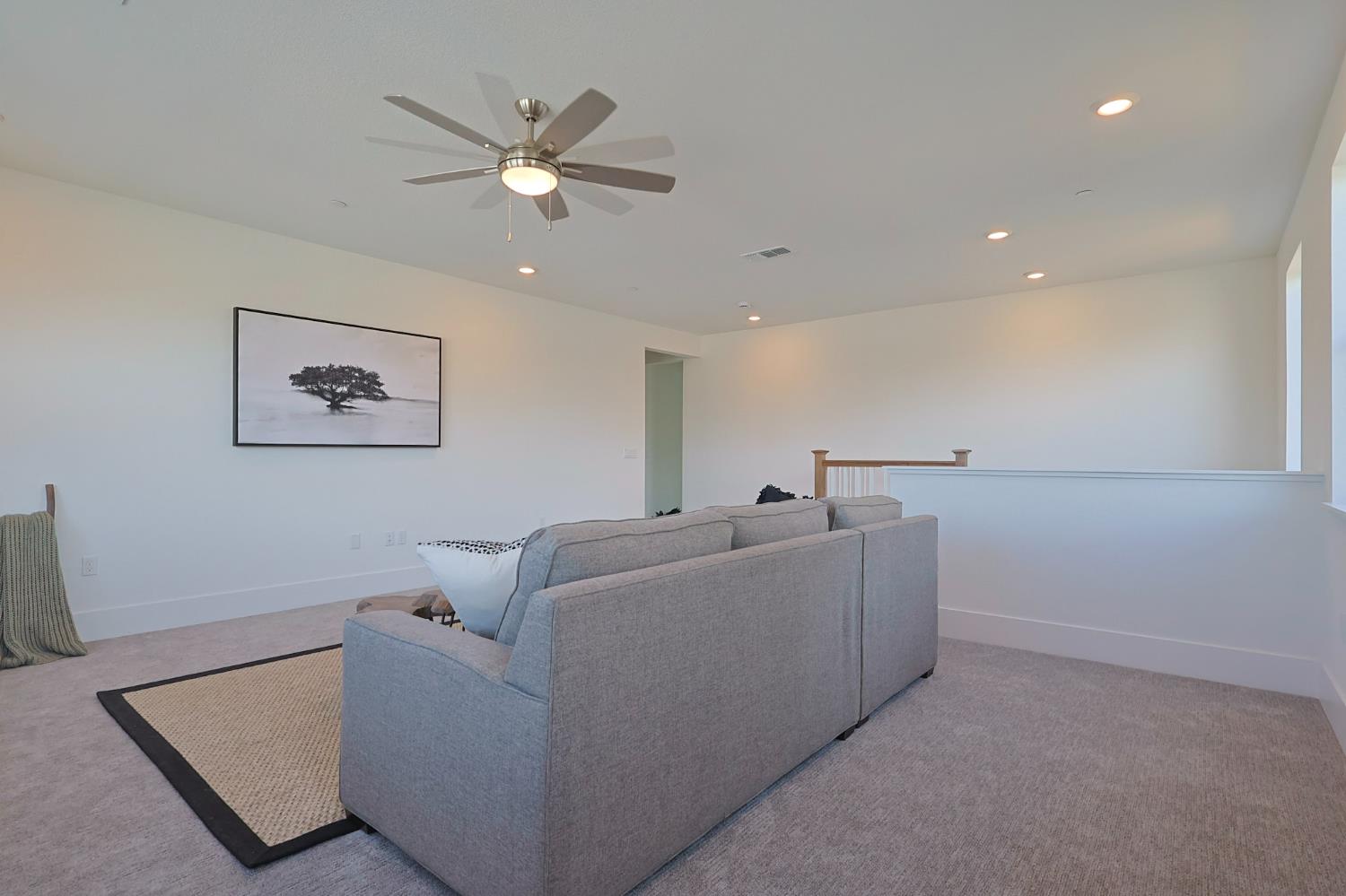 5638 Lakepointe Drive Rocklin, CA 95677 - Photo 19 of 30 a living room with furniture and a ceiling fan
