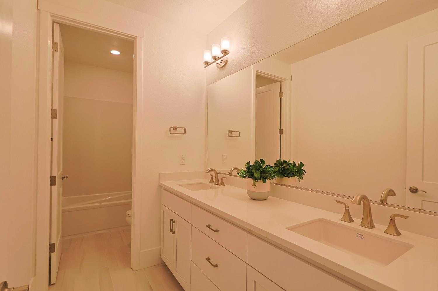 5638 Lakepointe Drive Rocklin, CA 95677 - Photo 22 of 30 a bathroom with a double vanity sink and a mirror