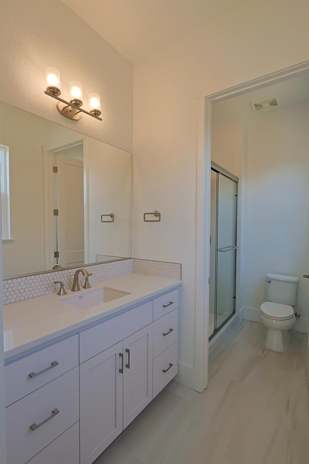 5638 Lakepointe Drive Rocklin, CA 95677 - Photo 24 of 30 a spacious bathroom with a granite countertop sink mirror and toilet