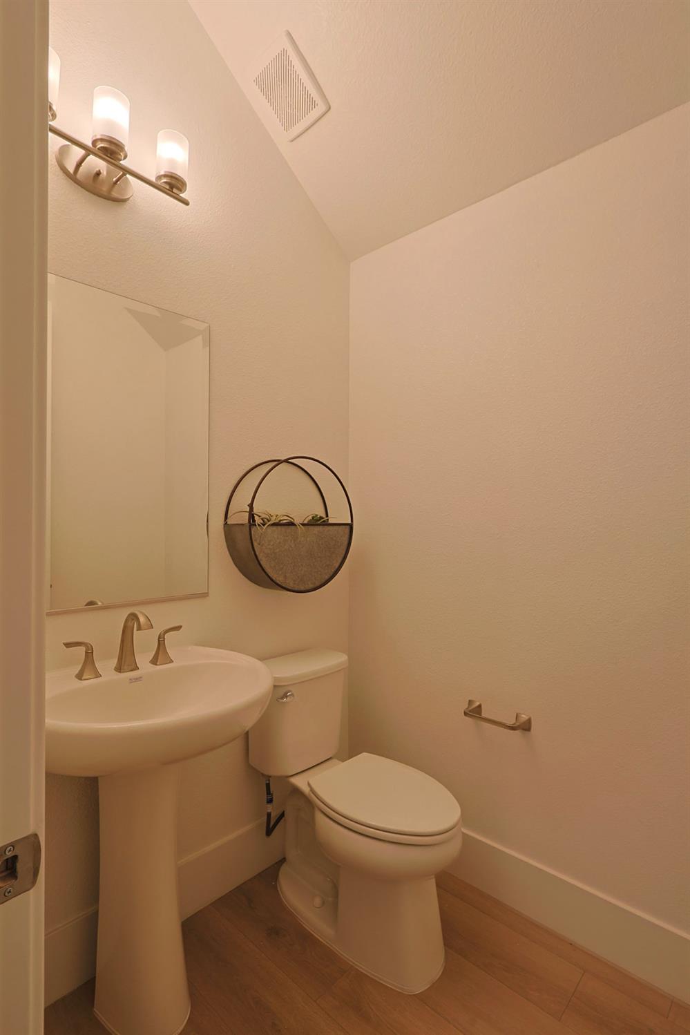 5638 Lakepointe Drive Rocklin, CA 95677 - Photo 27 of 30 a bathroom with a toilet a sink and mirror