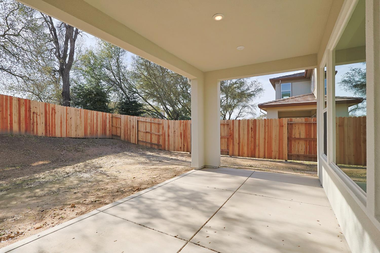 5638 Lakepointe Drive Rocklin, CA 95677 - Photo 29 of 30 a view of backyard with large trees and wooden fence