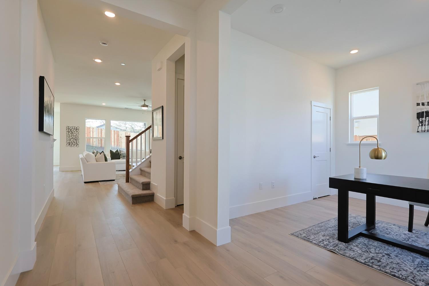 5638 Lakepointe Drive Rocklin, CA 95677 - Photo 3 of 30 a view of a hallway with wooden floor windows and a livingroom