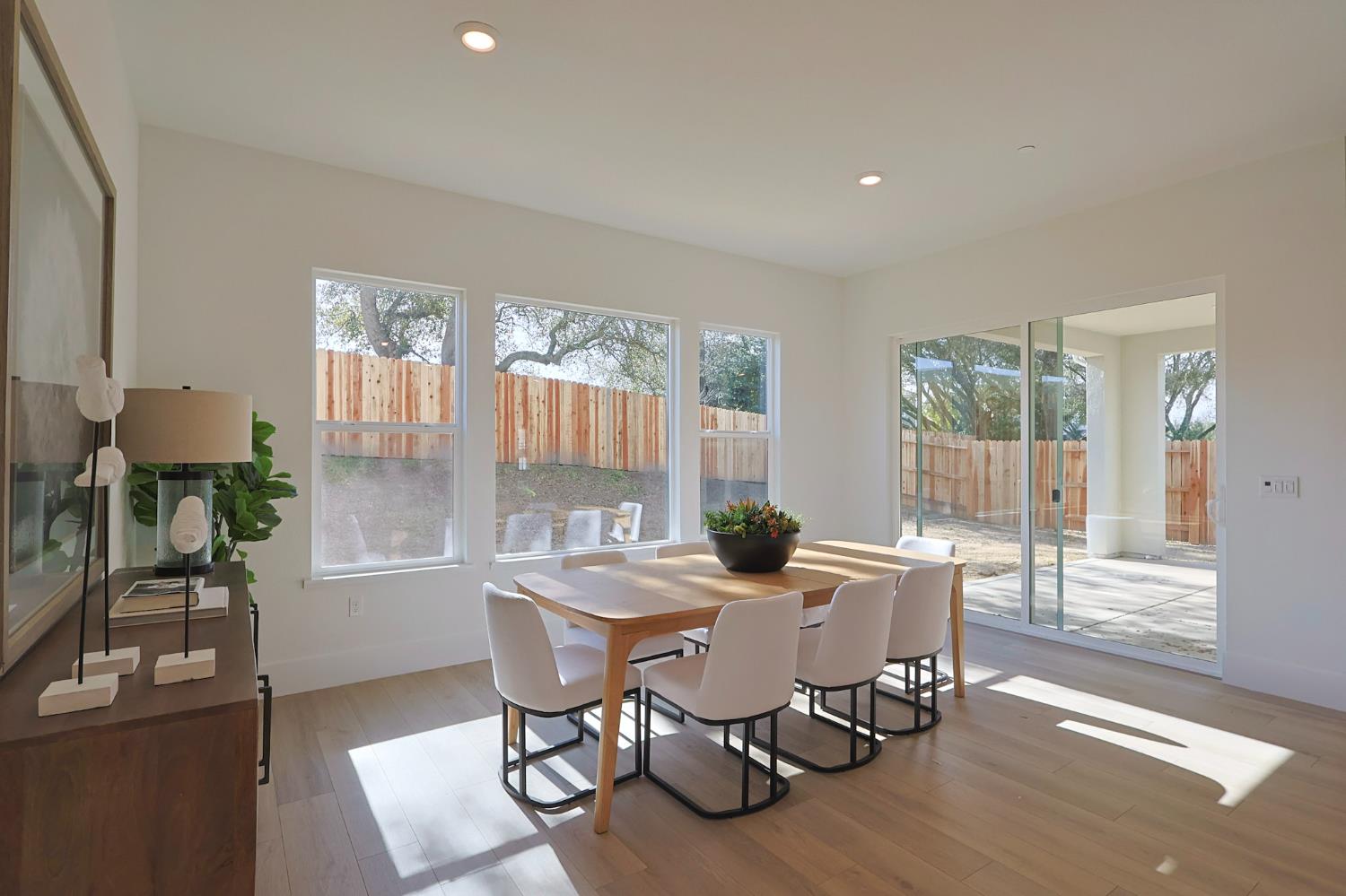 5638 Lakepointe Drive Rocklin, CA 95677 - Photo 9 of 30 a view of a dining room with furniture a chandelier and wooden floor