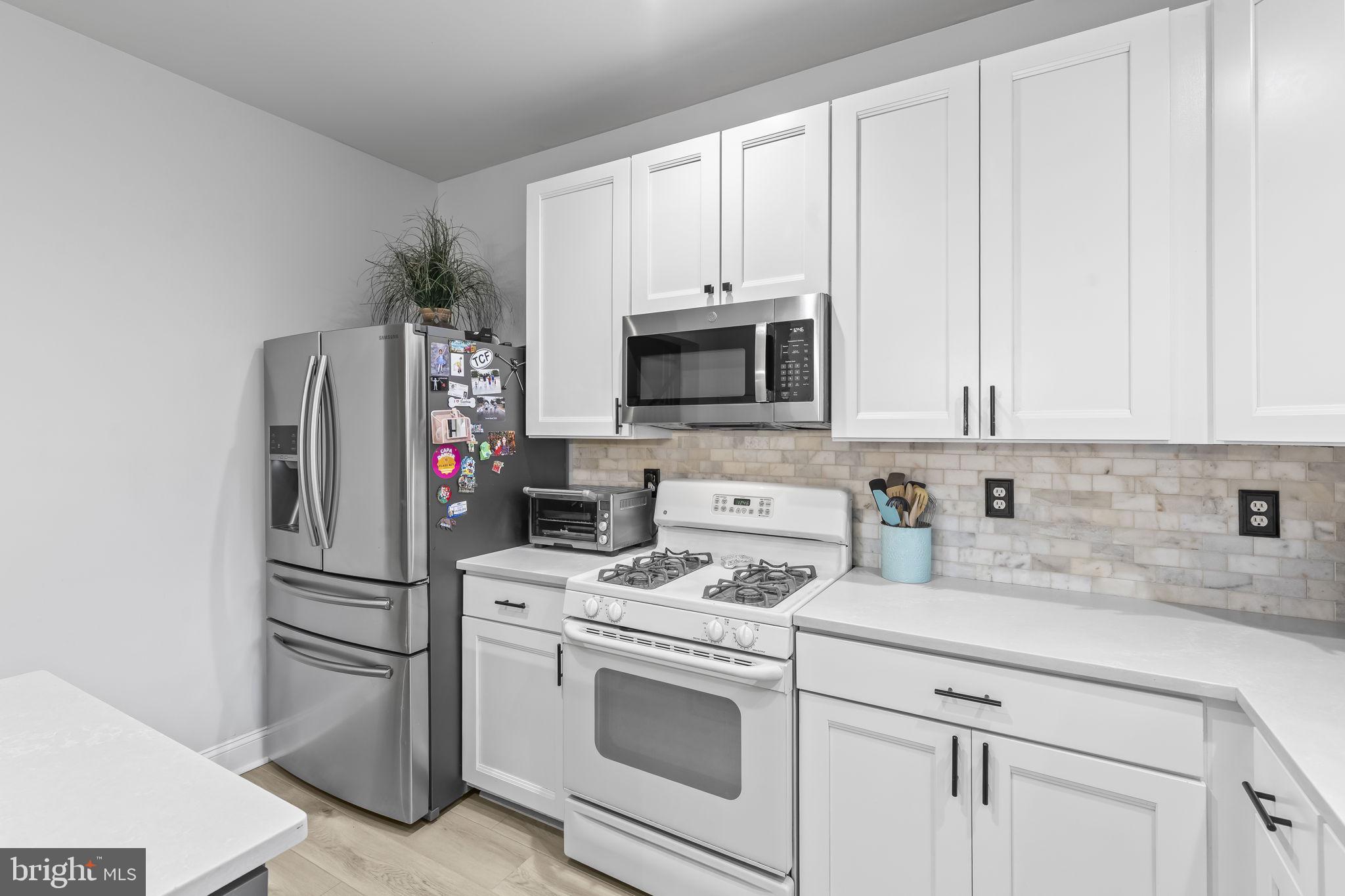 204 Braxton Way, Unit 204 Edgewater, MD 21037 - Photo 18 of 50 a kitchen with stainless steel appliances white cabinets and a refrigerator