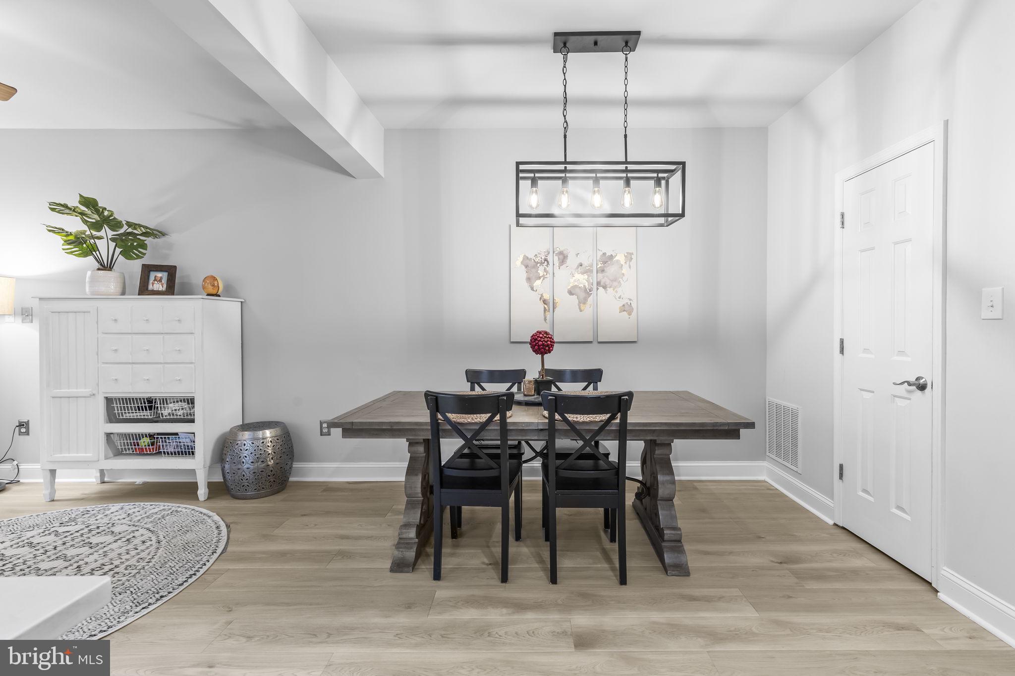204 Braxton Way, Unit 204 Edgewater, MD 21037 - Photo 21 of 50 a view of a dining room with furniture wooden floor and chandelier