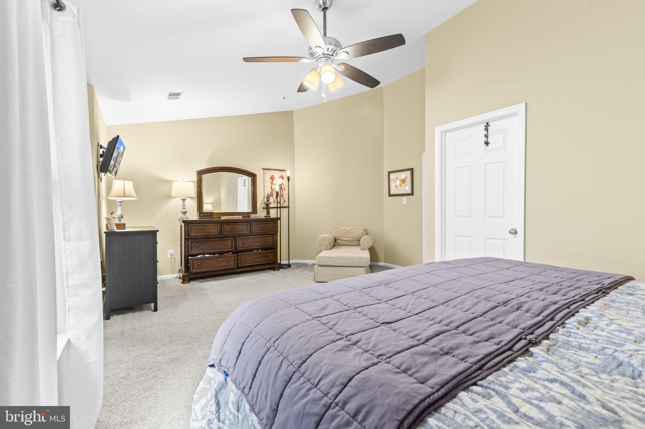 204 Braxton Way, Unit 204 Edgewater, MD 21037 - Photo 29 of 50 a bedroom with a bed and a chandelier