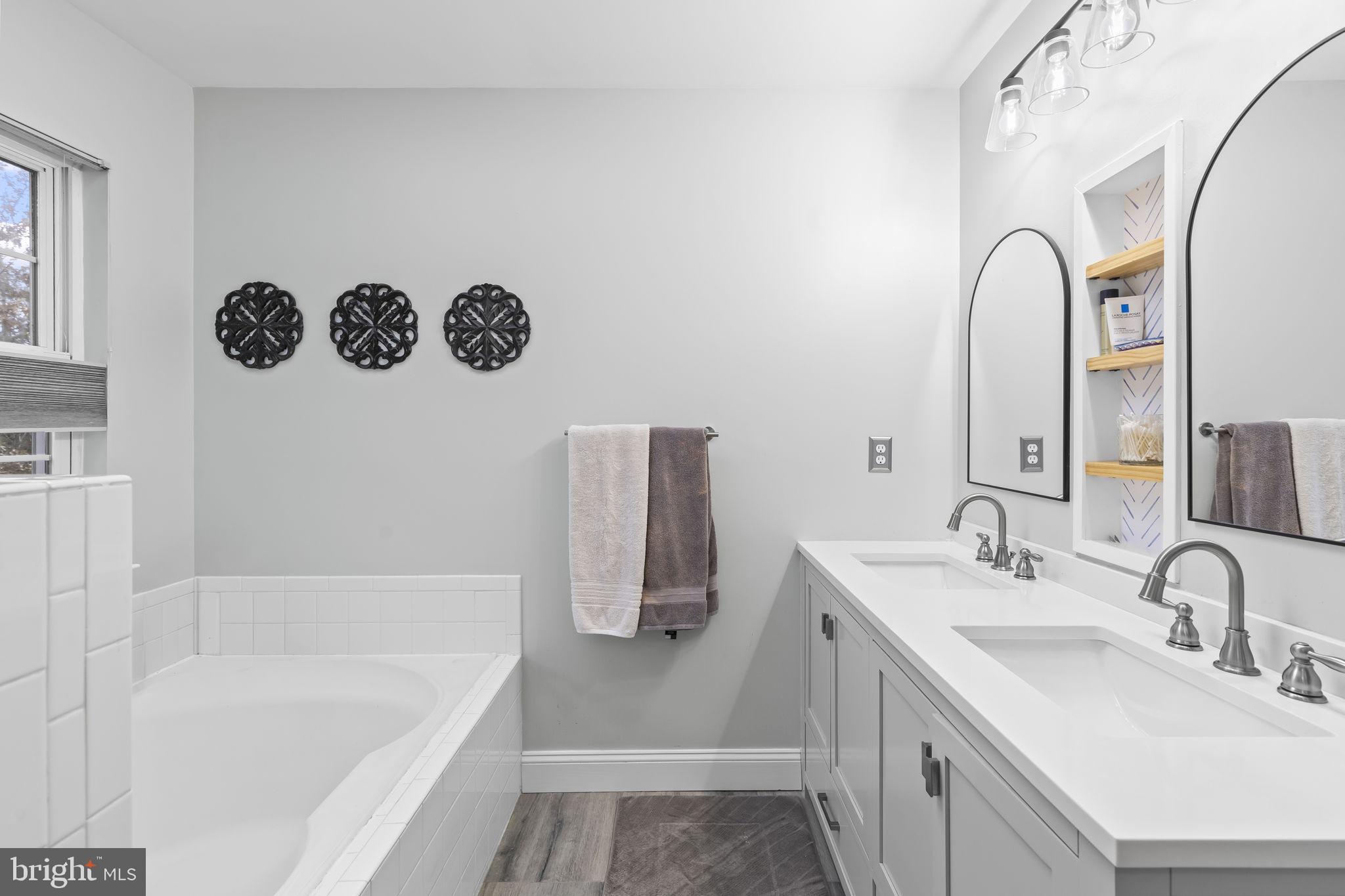 204 Braxton Way, Unit 204 Edgewater, MD 21037 - Photo 32 of 50 a bathroom with a tub sink and mirror
