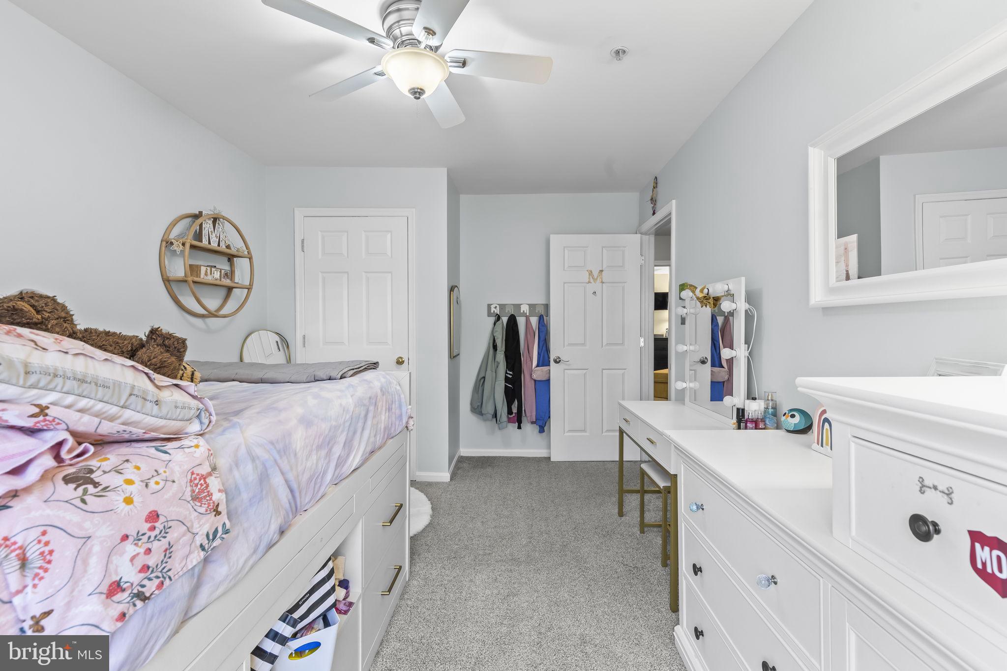 204 Braxton Way, Unit 204 Edgewater, MD 21037 - Photo 38 of 50 a bedroom with a bed and a chandelier