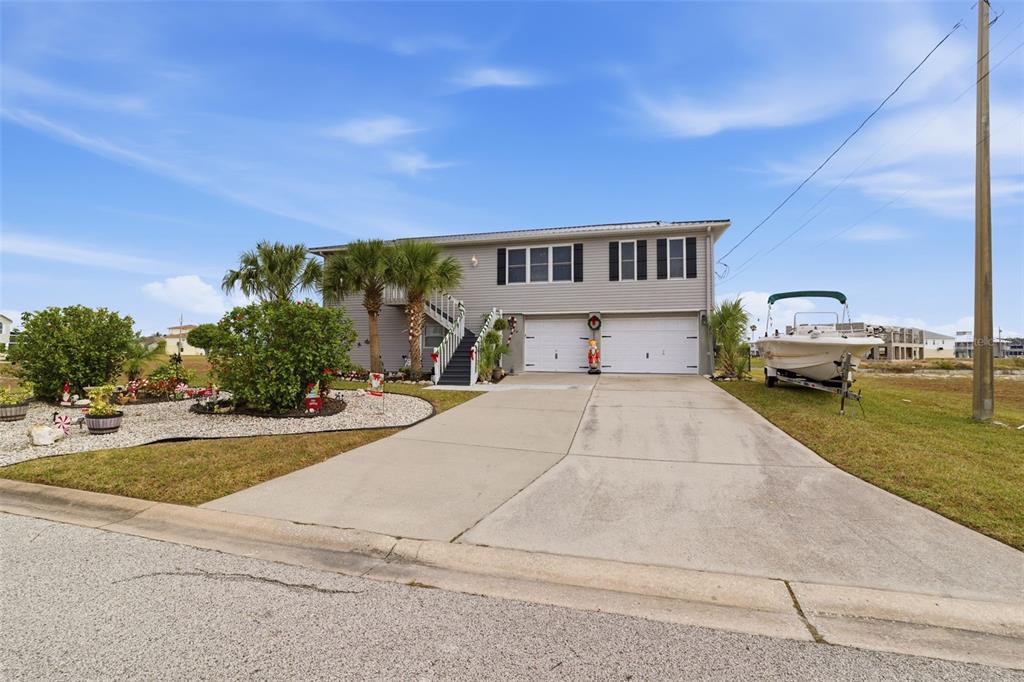 3366 Bluefish Drive Hernando Beach, FL 34607 - Photo 2 of 75 a front view of a house with a garden and parking