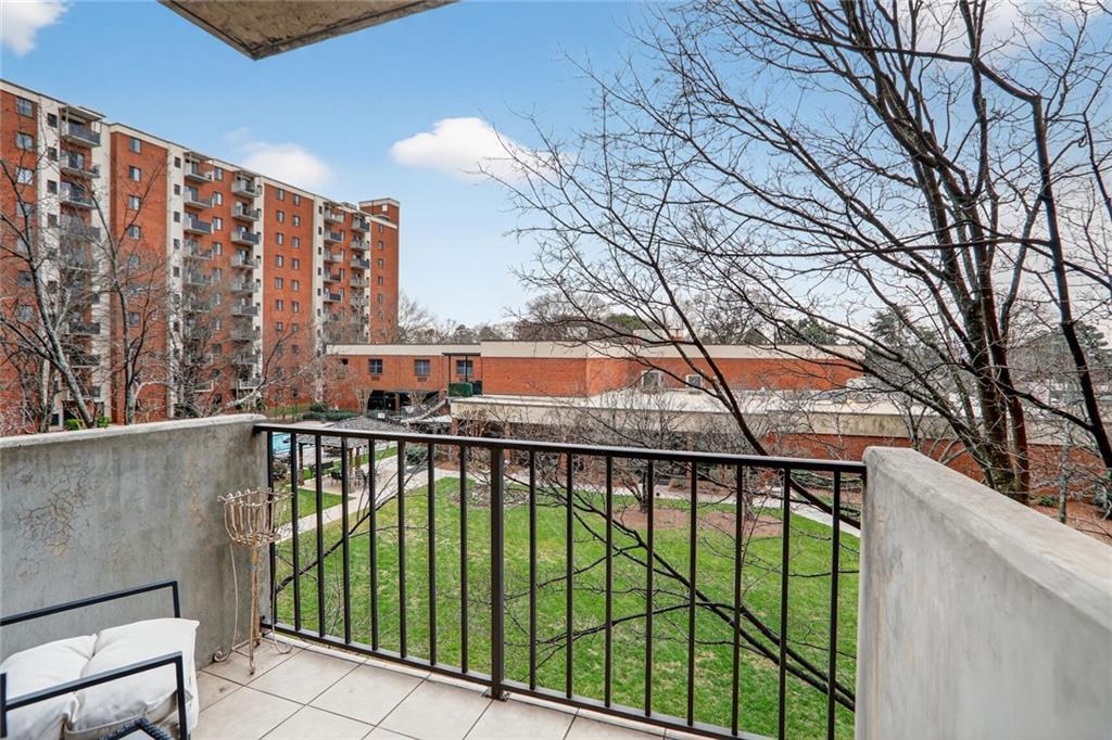 a view of a balcony with yard