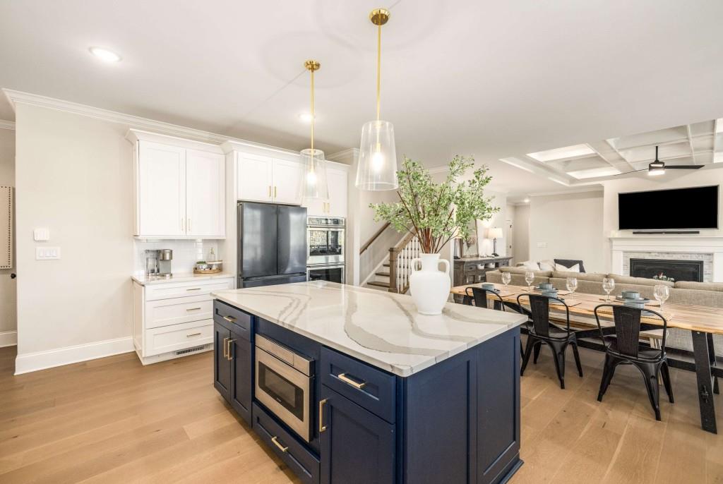 4045 Haven Terrace Milton, GA 30004 - Photo 16 of 46 a living room with stainless steel appliances kitchen island granite countertop a stove a sink a dining table and chairs