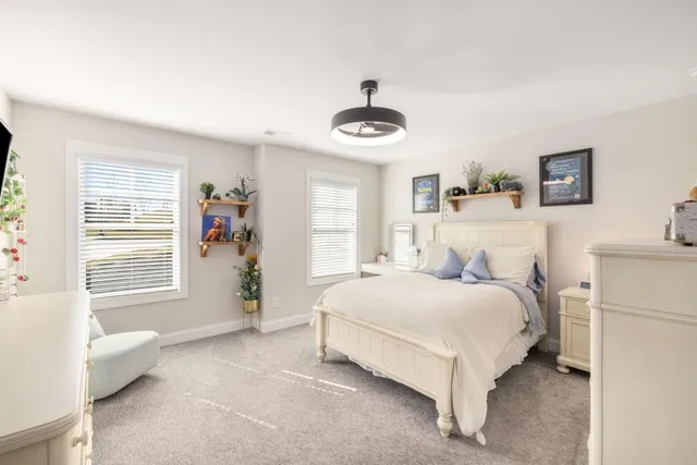 a bedroom with a bed and a large window