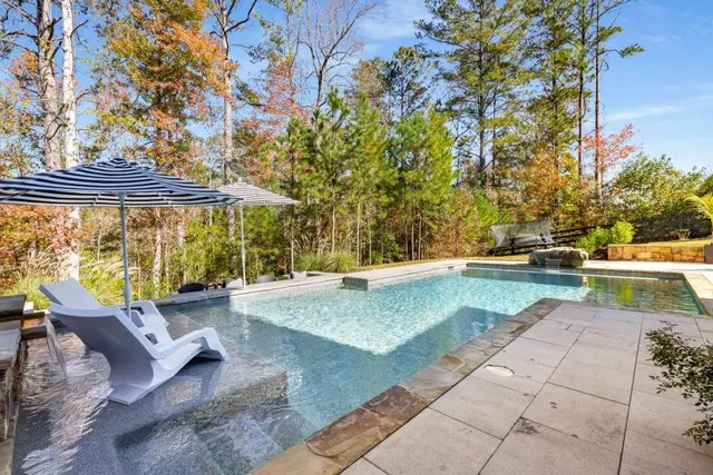a view of swimming pool with seating area