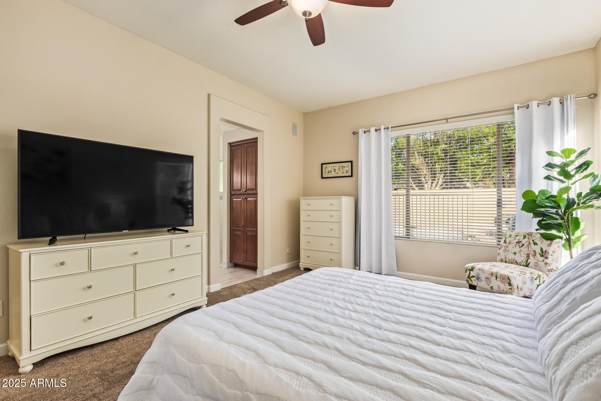 535 South Lemon Court Gilbert, AZ 85296 - Photo 15 of 36 a bedroom with a bed and a flat screen tv