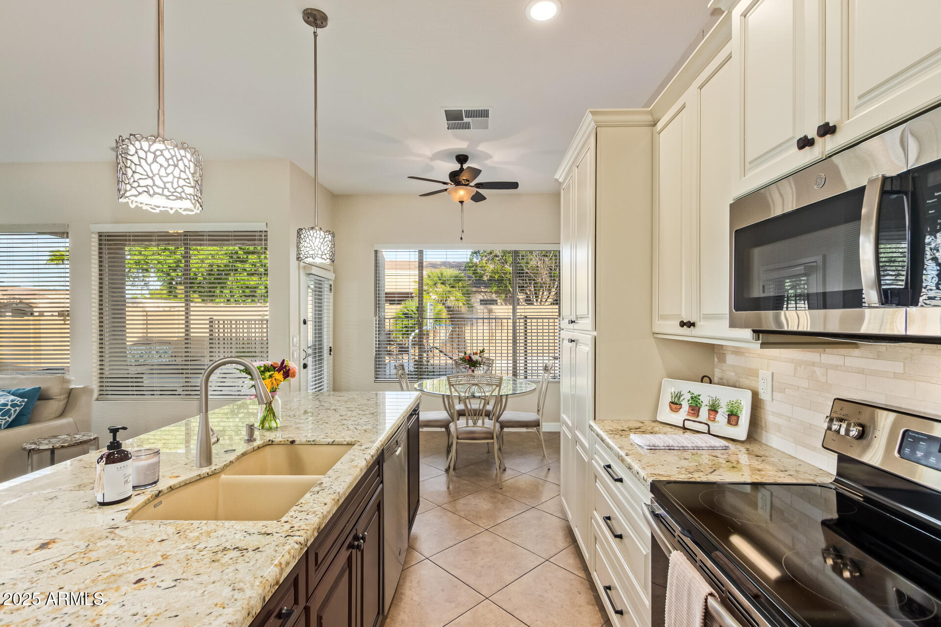535 South Lemon Court Gilbert, AZ 85296 - Photo 2 of 36 a kitchen with granite countertop a sink stove and cabinets