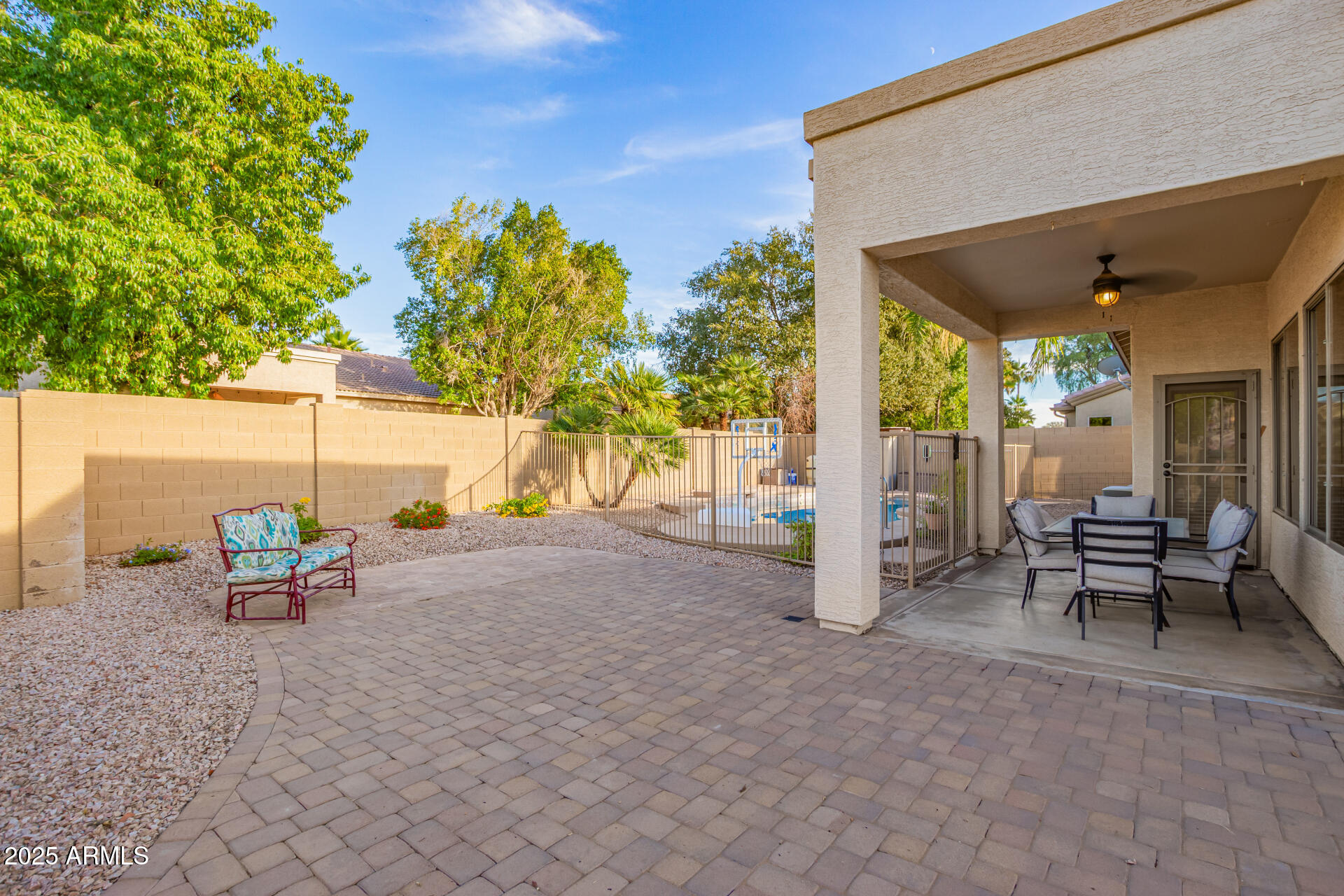 535 South Lemon Court Gilbert, AZ 85296 - Photo 29 of 36 a view of a patio with table and chairs and floor to ceiling window and tree
