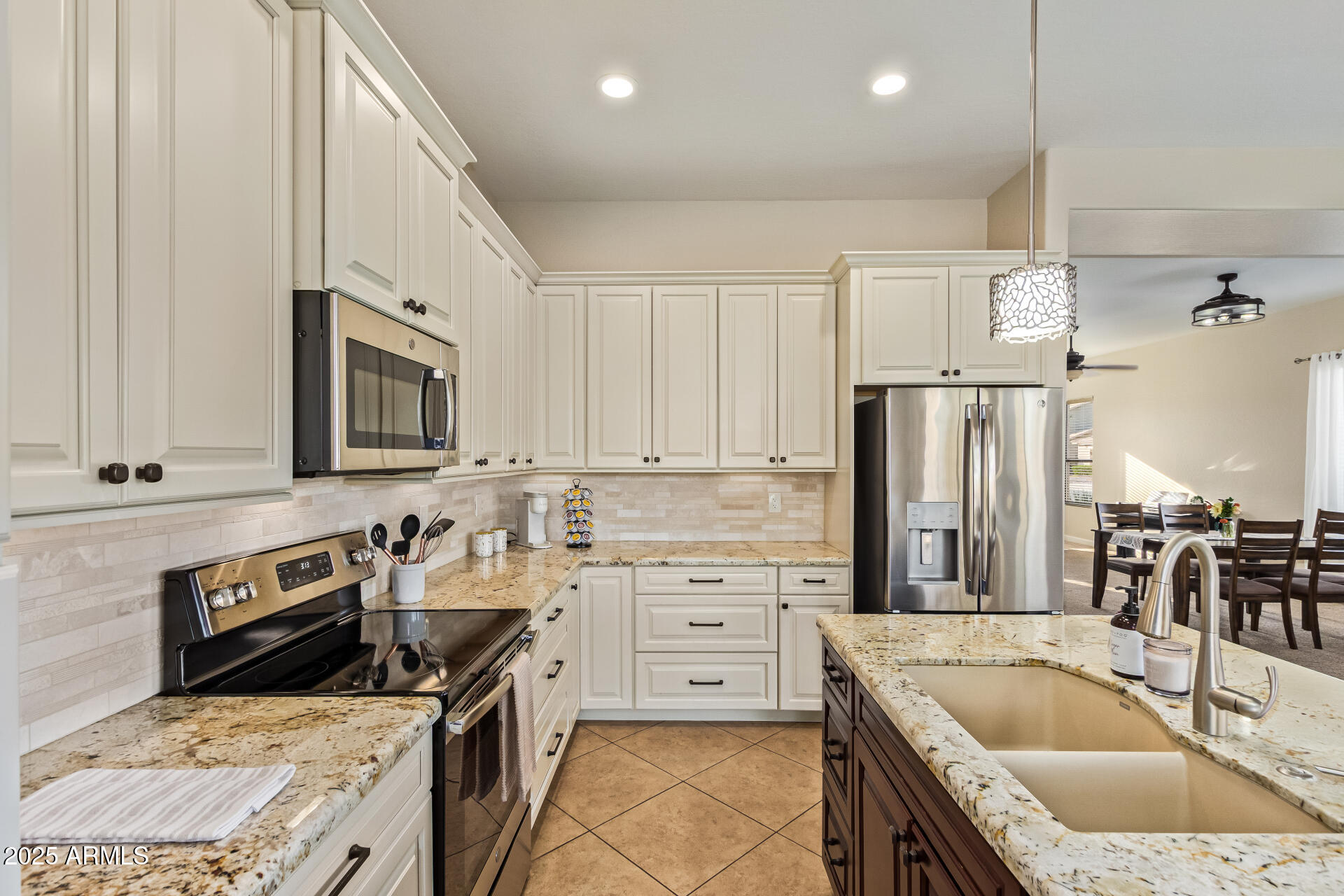 535 South Lemon Court Gilbert, AZ 85296 - Photo 4 of 36 a kitchen with stainless steel appliances granite countertop a sink stove and refrigerator
