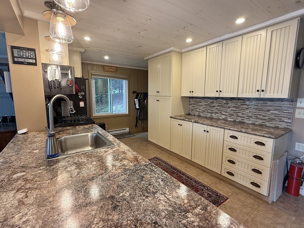 46 Bray Road Chesterfield, MA 01012 - Photo 9 of 12 a kitchen with granite countertop a sink stove and cabinets