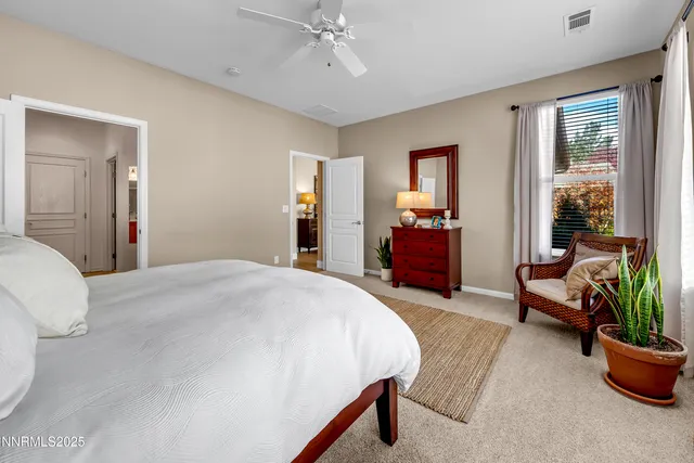 a bedroom with bed and a potted plant