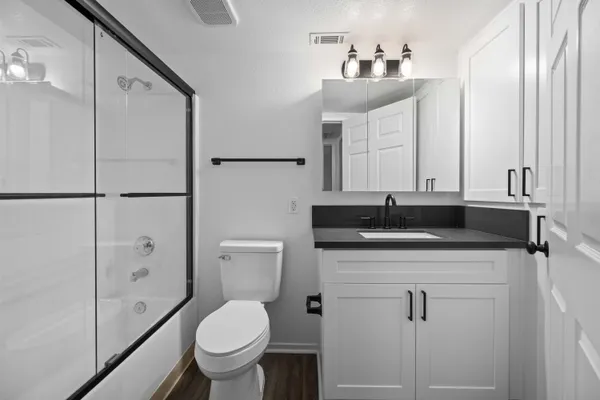 a bathroom with a sink toilet and shower