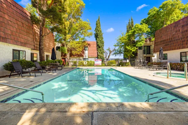 a view of backyard with swimming pool