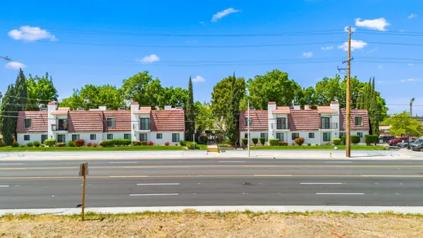a view of a street with a building in the background