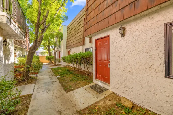 a view of a pathway both side of the house