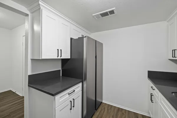 a kitchen with a cabinet and a refrigerator