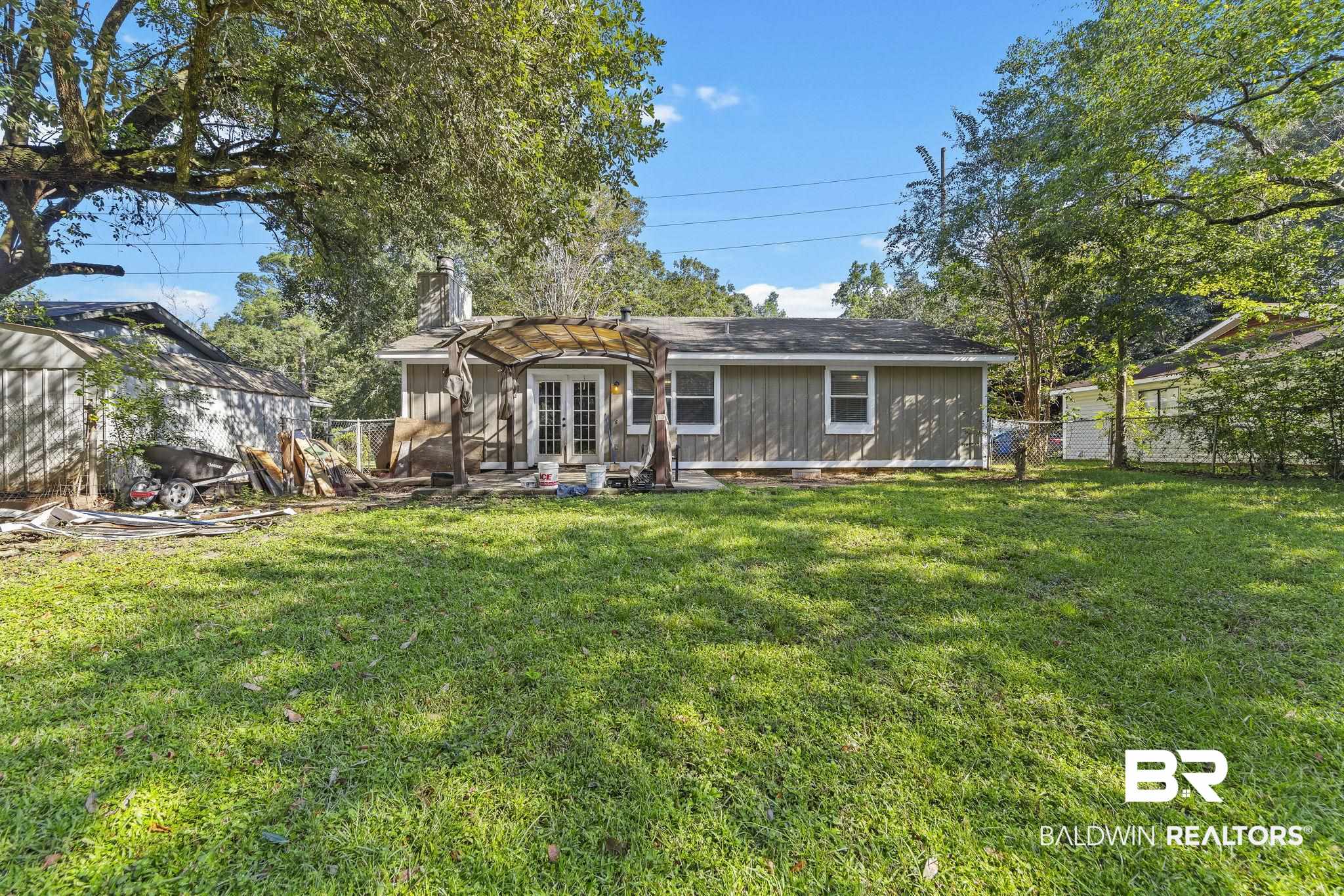 4151 Springdale Road Mobile, AL 36609 - Photo 19 of 21 Rear view of house featuring french doors and a yard