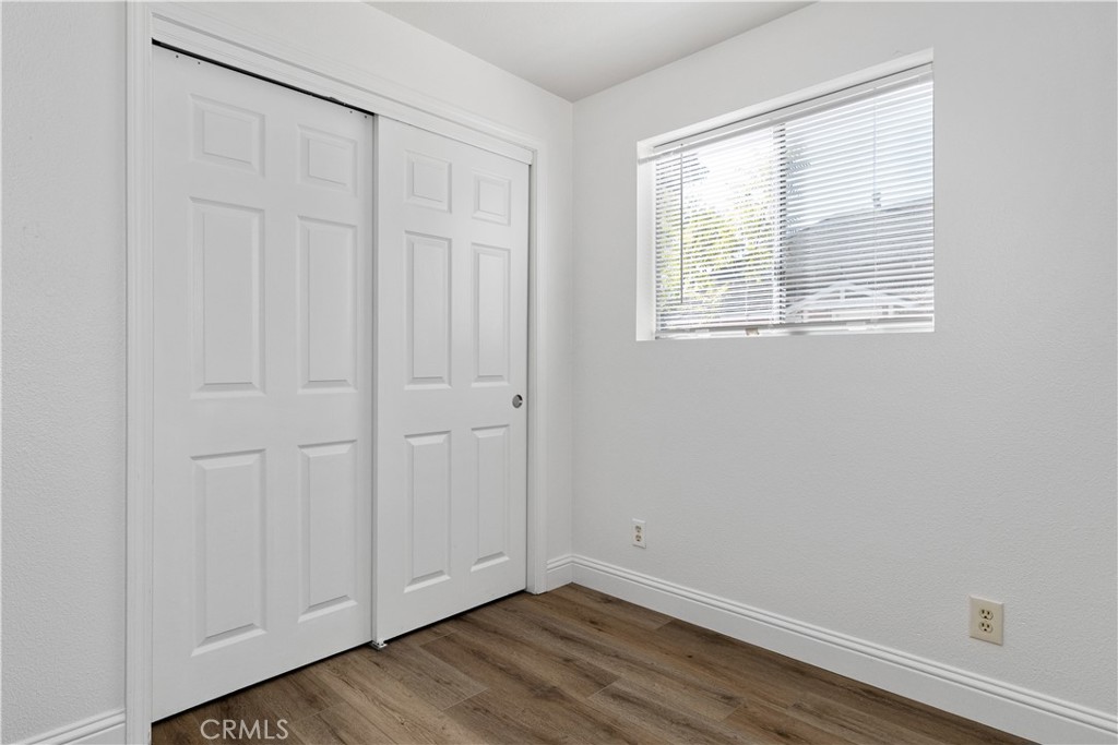 317 Crocker Street Templeton, CA 93465 - Photo 12 of 36 a view of an empty room with wooden floor and a window