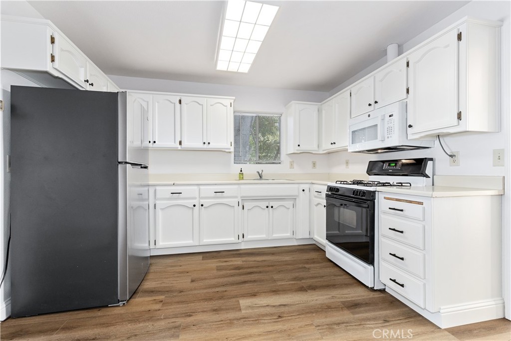 317 Crocker Street Templeton, CA 93465 - Photo 16 of 36 a kitchen with white cabinets sink and stainless steel appliances
