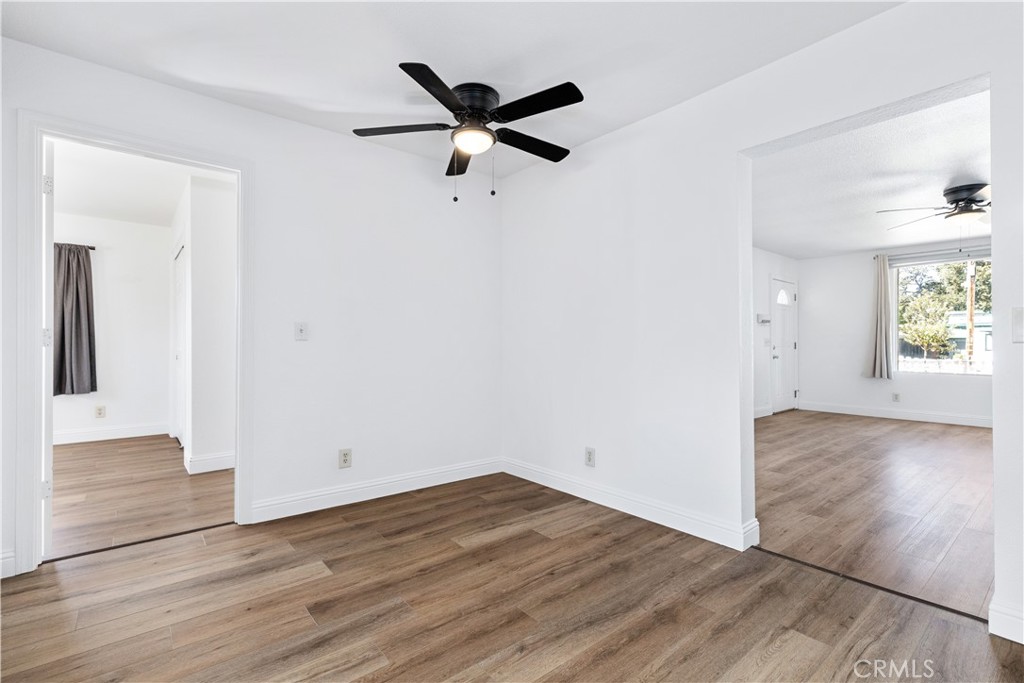 317 Crocker Street Templeton, CA 93465 - Photo 19 of 36 an empty room with wooden floor a ceiling fan and windows