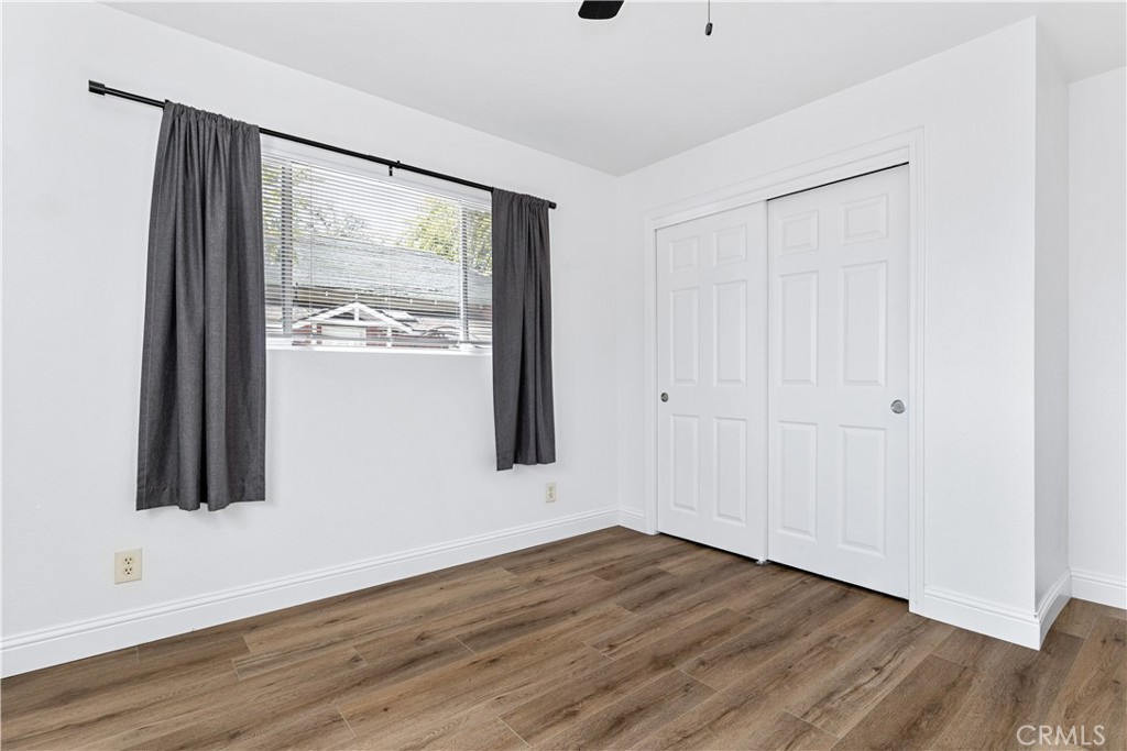 317 Crocker Street Templeton, CA 93465 - Photo 22 of 36 a view of an empty room with wooden floor and a window