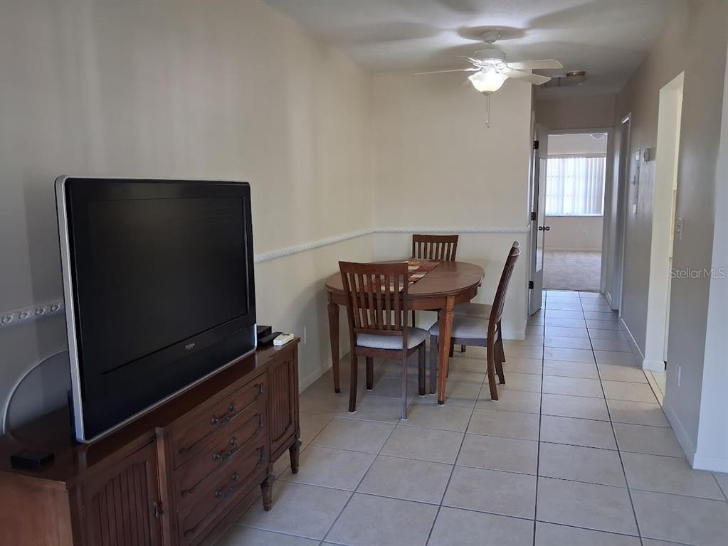 4744 Azalea Drive, Unit 204 New Port Richey, FL 34652 - Photo 5 of 20 a dining room with furniture and wooden floor