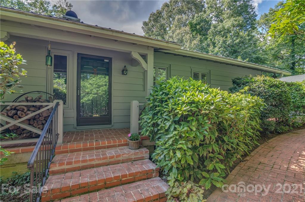 811 Hunting Country Road Tryon, NC 28782 - Photo 2 of 40 a front view of a house with garden