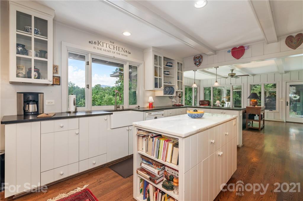 811 Hunting Country Road Tryon, NC 28782 - Photo 12 of 40 a kitchen with kitchen island granite countertop a stove and a large window