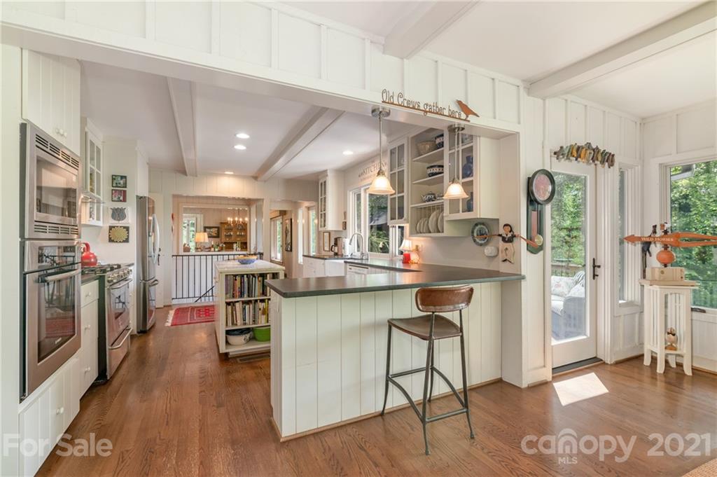 811 Hunting Country Road Tryon, NC 28782 - Photo 15 of 40 a kitchen with stainless steel appliances granite countertop a refrigerator and a stove top oven