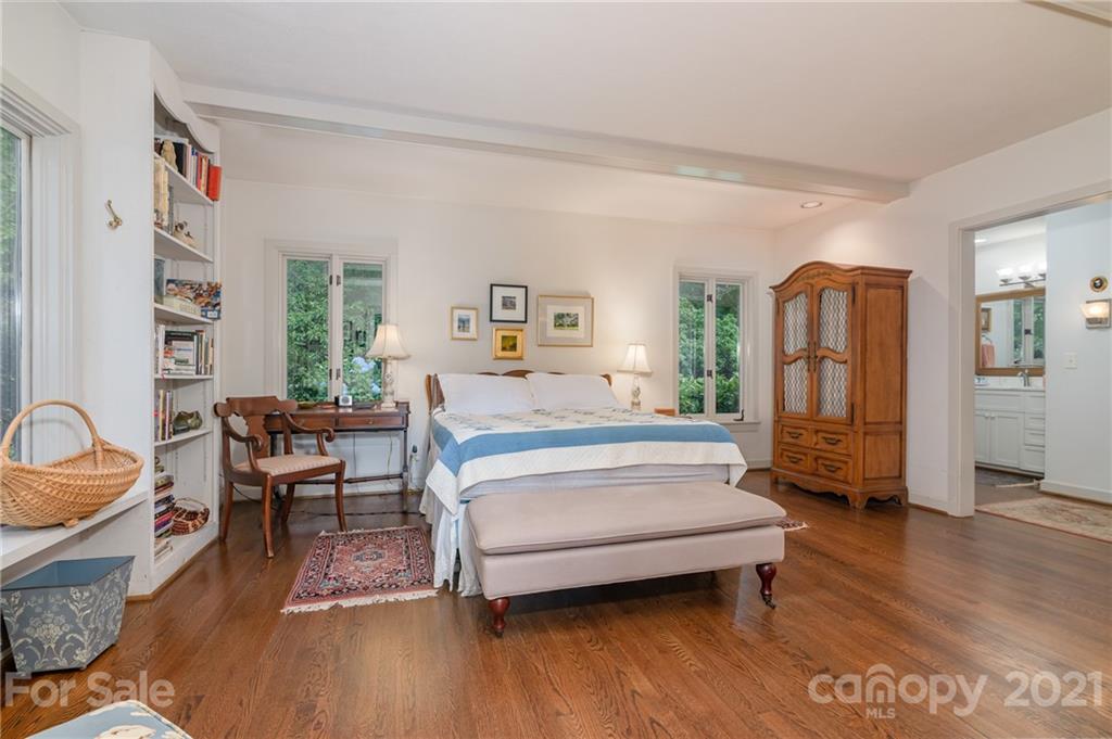 811 Hunting Country Road Tryon, NC 28782 - Photo 20 of 40 a spacious bedroom with a bed and a couch