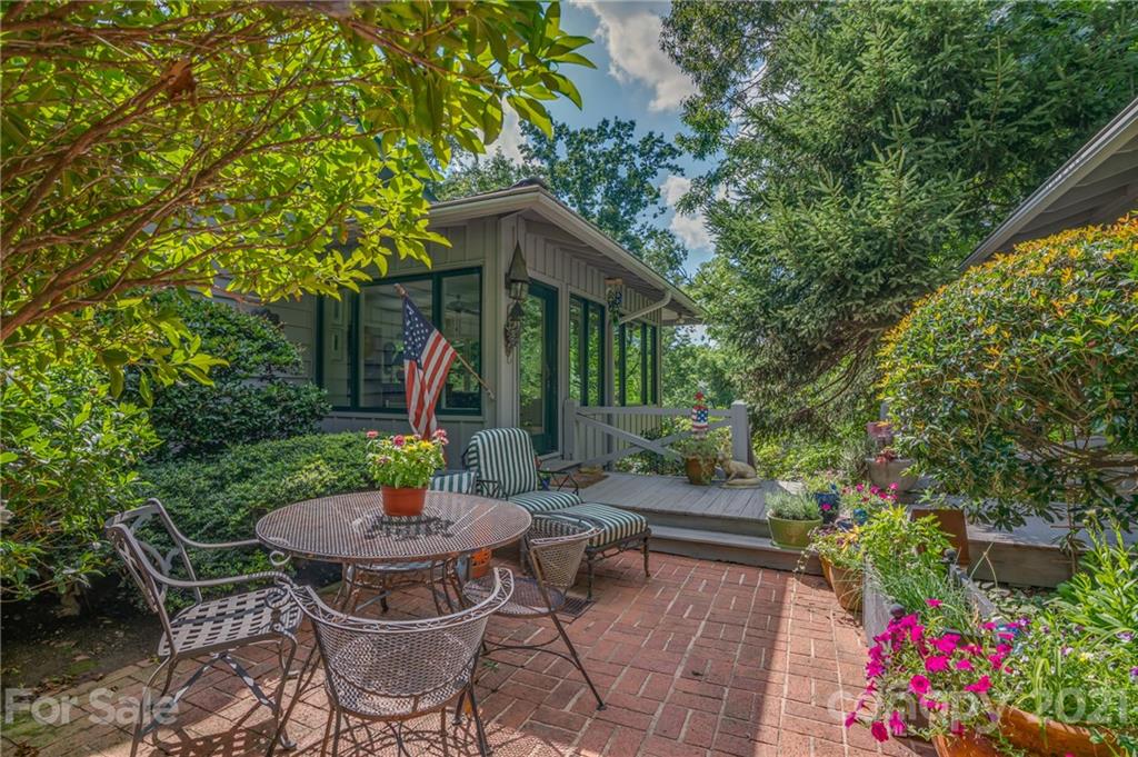 811 Hunting Country Road Tryon, NC 28782 - Photo 3 of 40 a view of a patio with table and chairs and potted plants