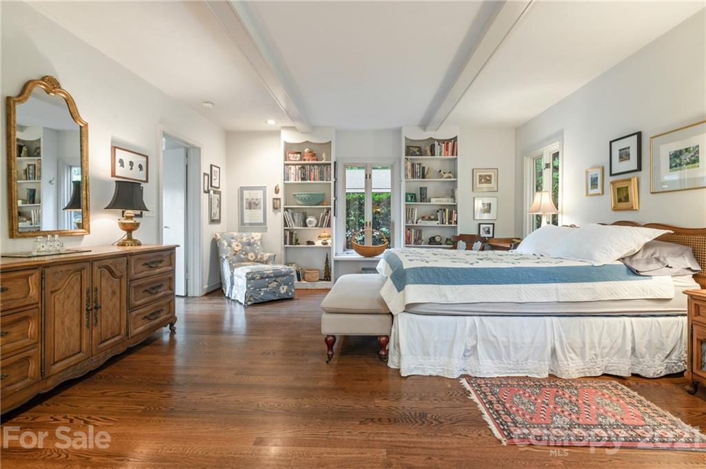 811 Hunting Country Road Tryon, NC 28782 - Photo 21 of 40 a spacious bedroom with a large bed and a couch